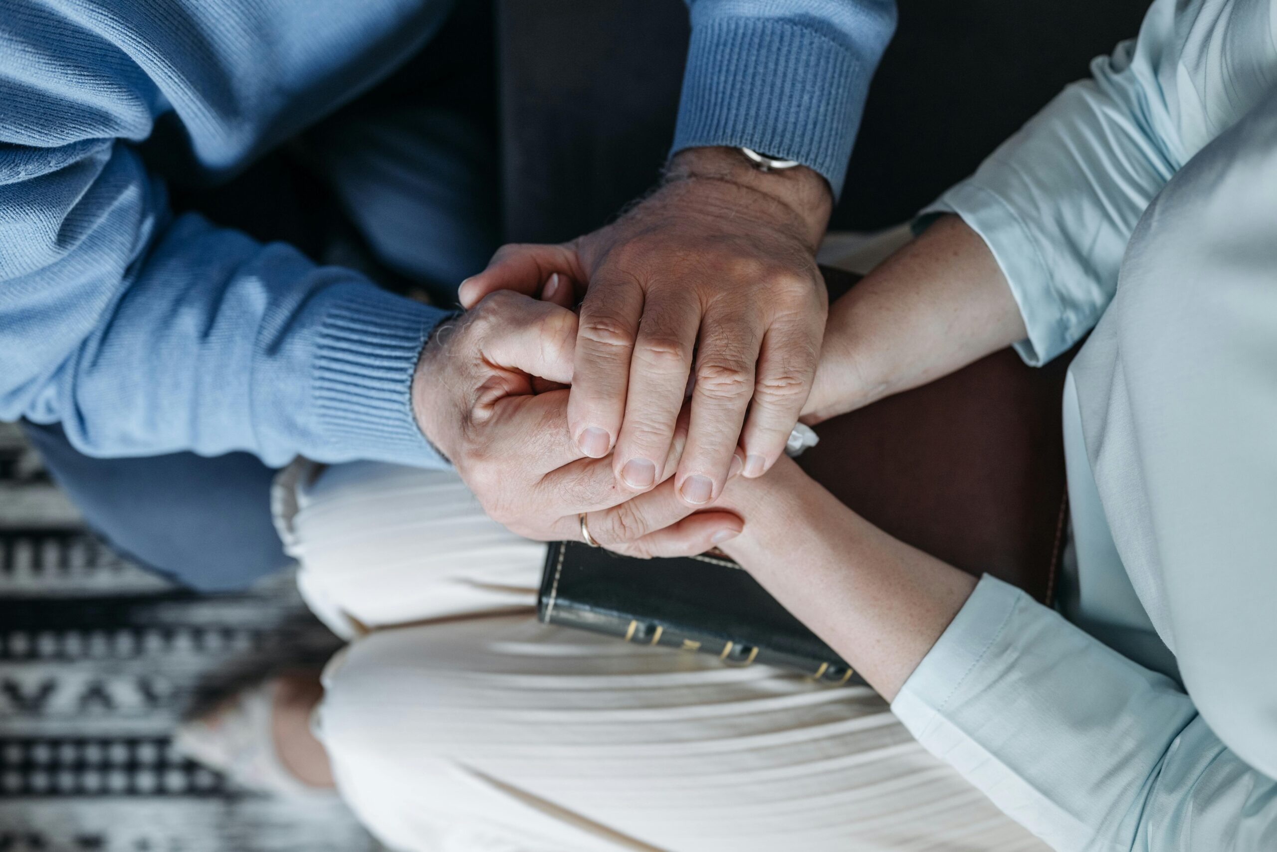 Couple holding hands in support